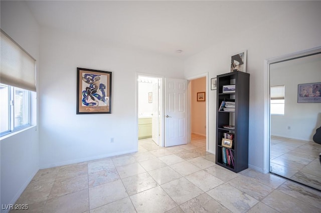 unfurnished bedroom featuring baseboards