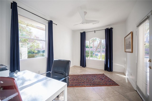 office area featuring light tile patterned floors, plenty of natural light, ceiling fan, and baseboards