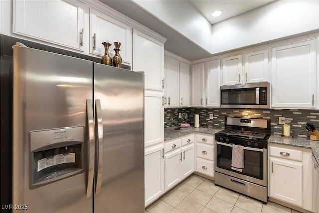 20 E Serene Ave Unit 111, Las Vegas, NV 89123 - kitchen with appliances with stainless steel finishes, light tile patterned floors, decorative backsplash, white cabinetry, and light stone countertops