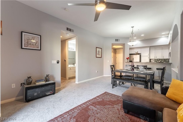 20 E Serene Ave Unit 111, Las Vegas, NV 89123 - living area featuring arched walkways, light colored carpet, ceiling fan, and baseboards