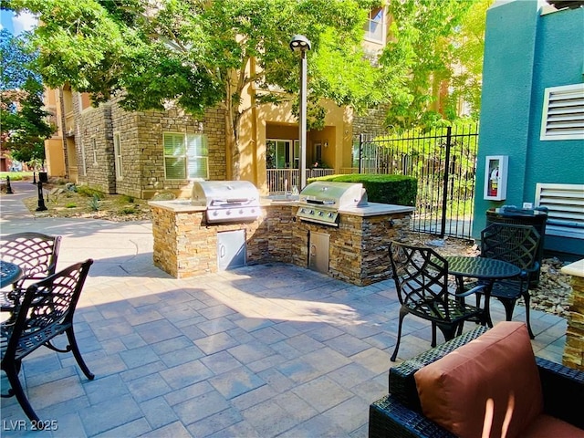 20 E Serene Ave Unit 111, Las Vegas, NV 89123 - view of patio / terrace with a grill, exterior kitchen, and fence