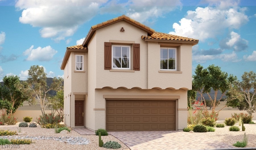mediterranean / spanish home featuring an attached garage, stucco siding, and a tile roof