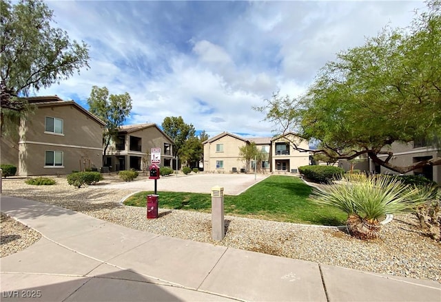 view of front of house featuring a residential view and a front lawn