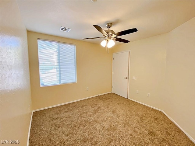 spare room featuring carpet flooring, ceiling fan, and baseboards