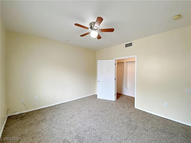 unfurnished room featuring carpet, ceiling fan, baseboards, and a smoke detector