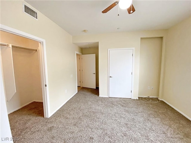 unfurnished bedroom with carpet flooring, baseboards, a ceiling fan, and a closet