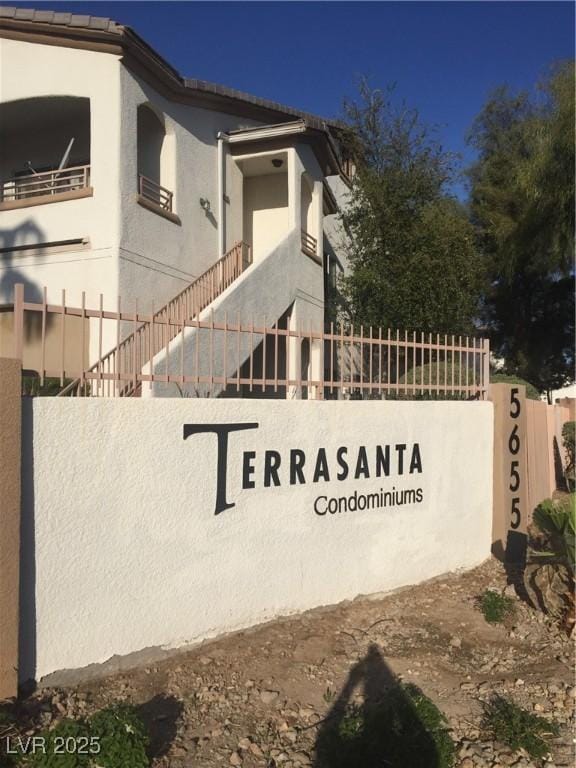 community / neighborhood sign with fence