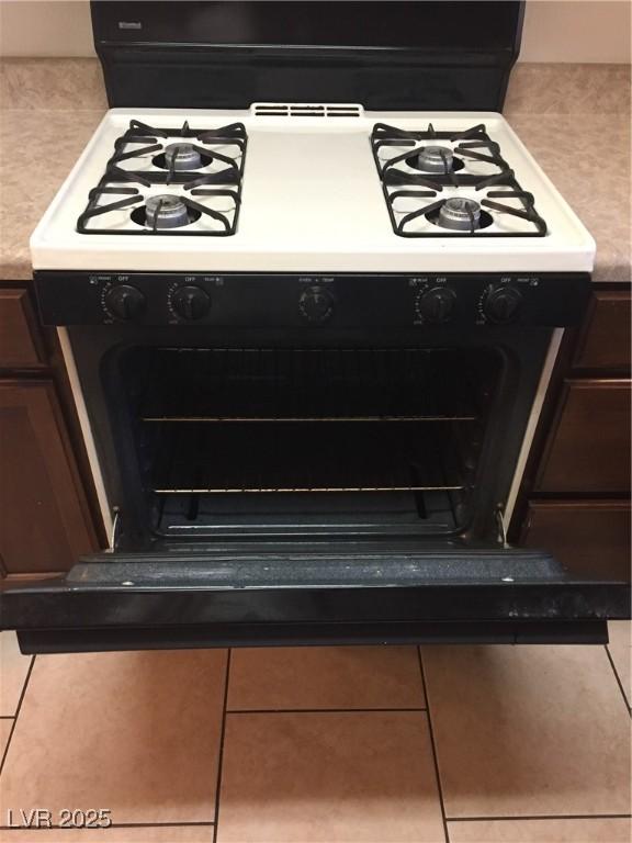 kitchen view of gas stove and backsplash