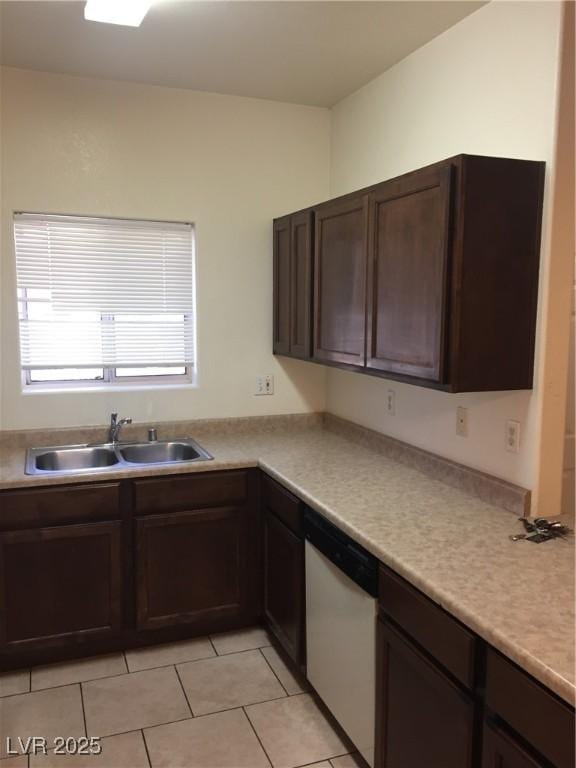 kitchen featuring dishwasher, a sink, dark brown cabinetry, light tile patterned flooring, and light countertops