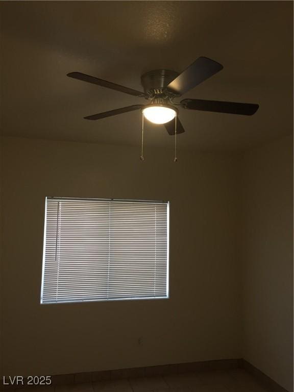 empty room with a ceiling fan, baseboards, and healthy amount of natural light