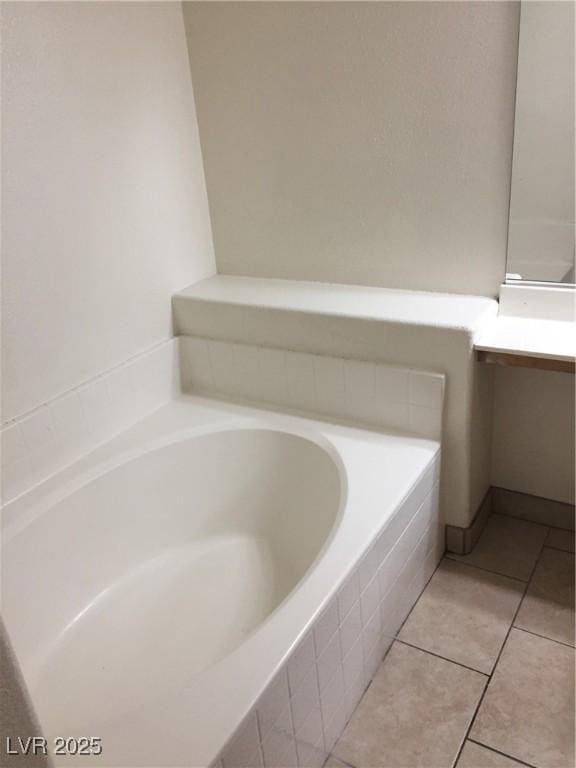 bathroom with a bath, vanity, and tile patterned floors