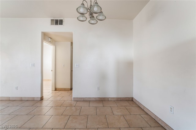 5655 E Sahara Ave Unit 1037, Las Vegas, NV 89142 - empty room with a chandelier, light tile patterned floors, and baseboards