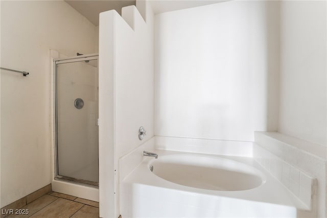 5655 E Sahara Ave Unit 1037, Las Vegas, NV 89142 - full bath featuring a stall shower, a bath, and tile patterned floors