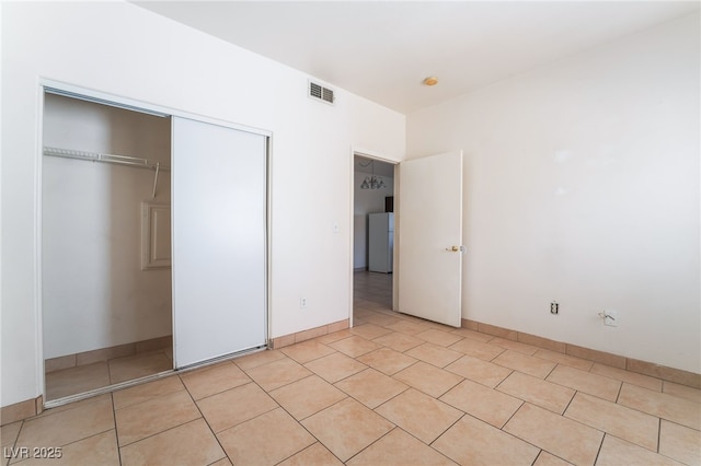 5655 E Sahara Ave Unit 1037, Las Vegas, NV 89142 - unfurnished bedroom with a closet and light tile patterned flooring