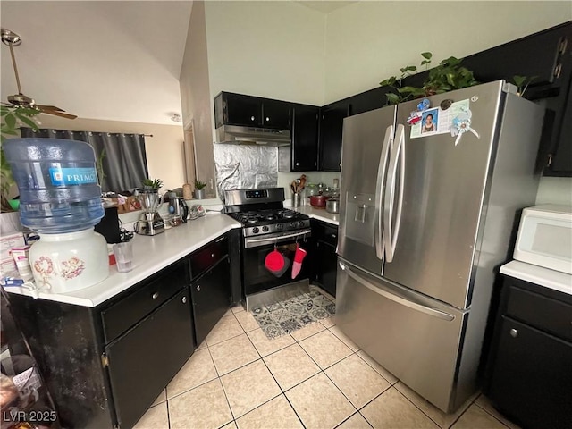 kitchen with appliances with stainless steel finishes, dark cabinets, light tile patterned floors, and light countertops