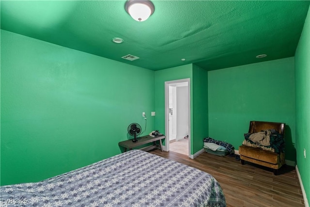 bedroom with wood finished floors and baseboards