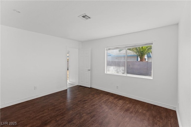 empty room with wood finished floors and baseboards