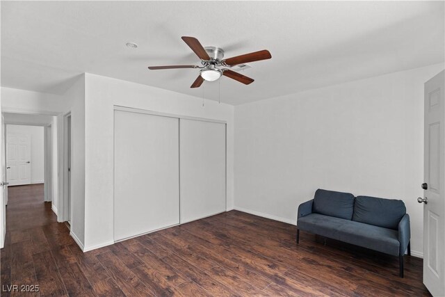 sitting room featuring ceiling fan, wood finished floors, and baseboards