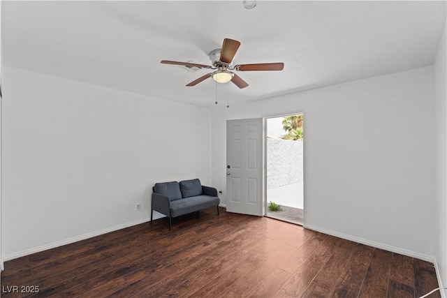 unfurnished room featuring hardwood / wood-style floors, a ceiling fan, and baseboards