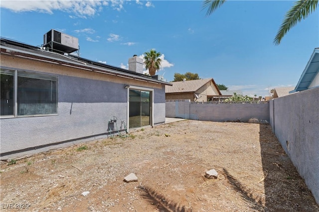 fenced backyard with central AC unit