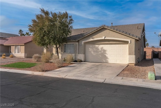 single story home featuring an attached garage, concrete driveway, stucco siding, fence, and a tile roof