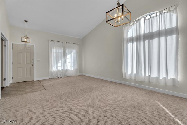 entryway with carpet, lofted ceiling, a chandelier, and baseboards