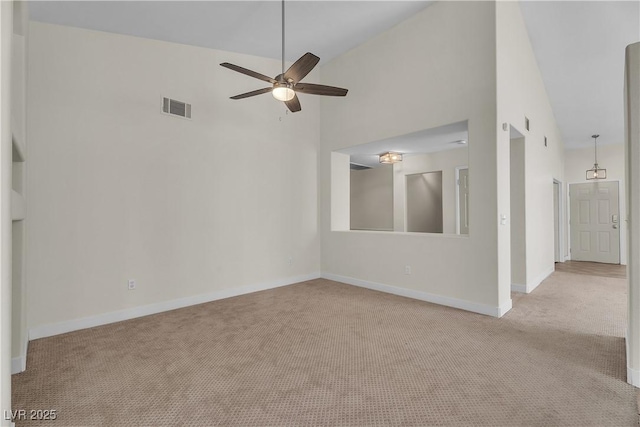 spare room featuring carpet flooring, ceiling fan, high vaulted ceiling, and baseboards