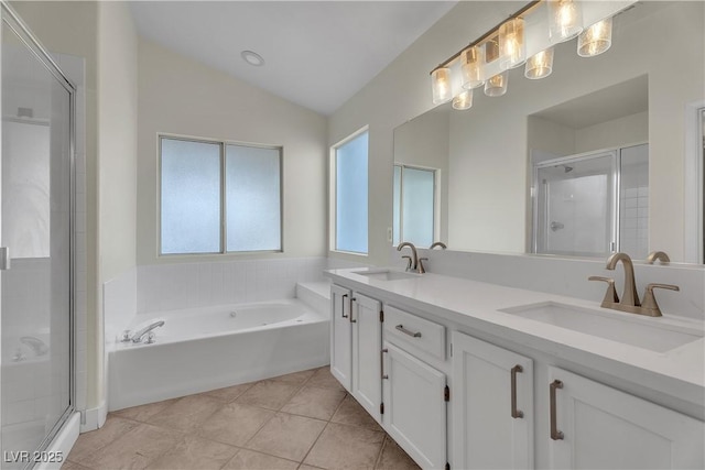 bathroom with vaulted ceiling, a shower stall, a bath, double vanity, and tile patterned floors