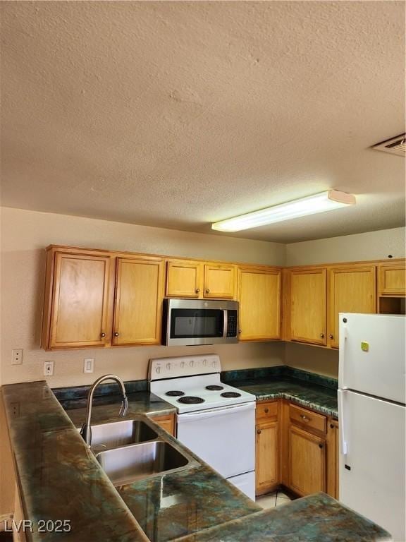 2974 Juniper Hills Blvd Unit 104, Las Vegas, NV 89142 - kitchen with white appliances, a textured ceiling, a sink, and dark countertops