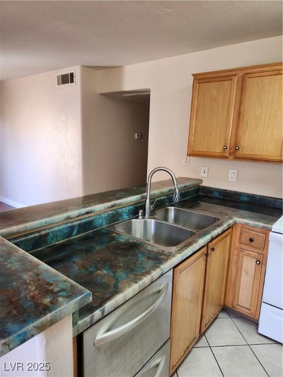 2974 Juniper Hills Blvd Unit 104, Las Vegas, NV 89142 - kitchen featuring a sink, stainless steel dishwasher, light tile patterned flooring, and a peninsula