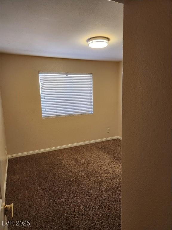 2974 Juniper Hills Blvd Unit 104, Las Vegas, NV 89142 - unfurnished room with carpet flooring and baseboards