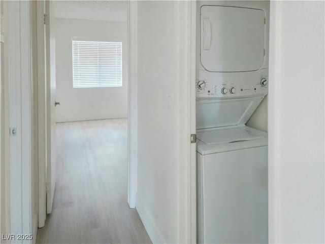 washroom with stacked washing machine and dryer