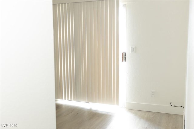 empty room with wood finished floors and baseboards