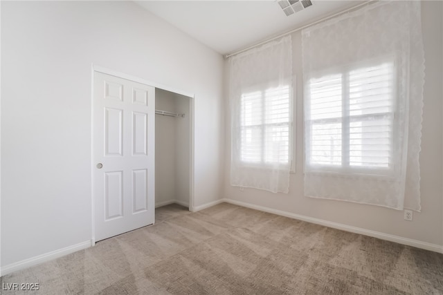 unfurnished bedroom with carpet flooring, a closet, and baseboards