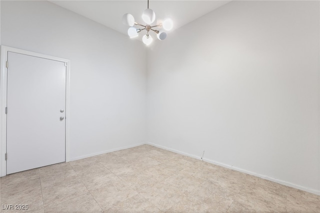 unfurnished room with a chandelier and baseboards
