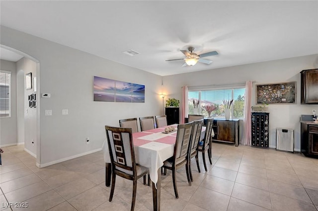 9656 Paraiso Springs St, Las Vegas, NV 89139 - dining space featuring arched walkways, a ceiling fan, light tile patterned flooring, and baseboards
