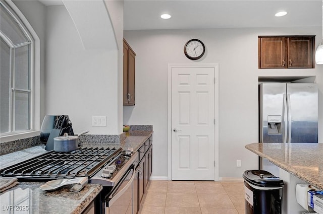 9656 Paraiso Springs St, Las Vegas, NV 89139 - kitchen featuring range, stone countertops, light tile patterned flooring, stainless steel refrigerator with ice dispenser, and recessed lighting