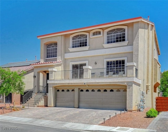 9656 Paraiso Springs St, Las Vegas, NV 89139 - mediterranean / spanish-style home featuring stucco siding, a garage, a balcony, and driveway