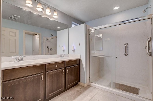 9656 Paraiso Springs St, Las Vegas, NV 89139 - bathroom featuring tile patterned floors, a shower stall, and double vanity