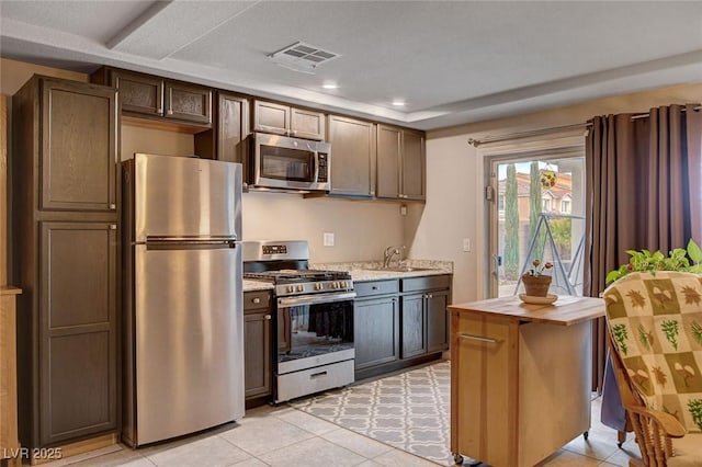 9656 Paraiso Springs St, Las Vegas, NV 89139 - kitchen featuring appliances with stainless steel finishes, light countertops, light tile patterned flooring, recessed lighting, and a sink