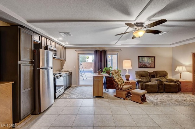 9656 Paraiso Springs St, Las Vegas, NV 89139 - living room featuring ceiling fan, a textured ceiling, and light tile patterned floors