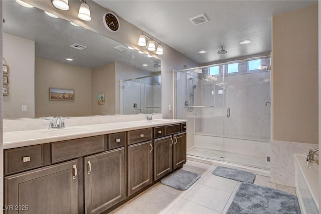 9656 Paraiso Springs St, Las Vegas, NV 89139 - bathroom with tile patterned flooring, a shower stall, double vanity, a bath, and recessed lighting