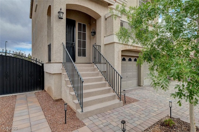 9656 Paraiso Springs St, Las Vegas, NV 89139 - doorway to property with stucco siding, a gate, and an attached garage