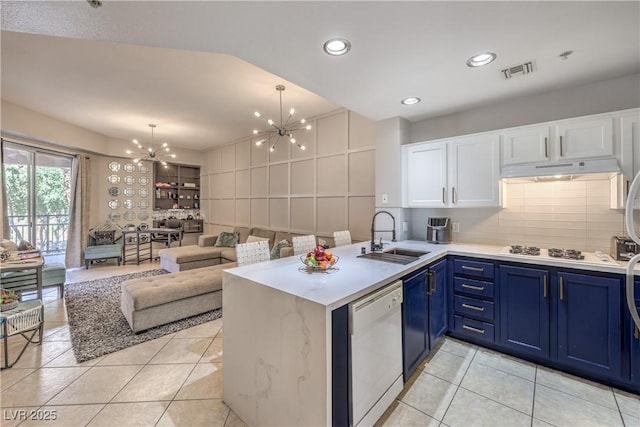 91 E Agate Ave Unit 204, Las Vegas, NV 89123 - kitchen featuring a sink, white appliances, a chandelier, under cabinet range hood, and blue cabinetry