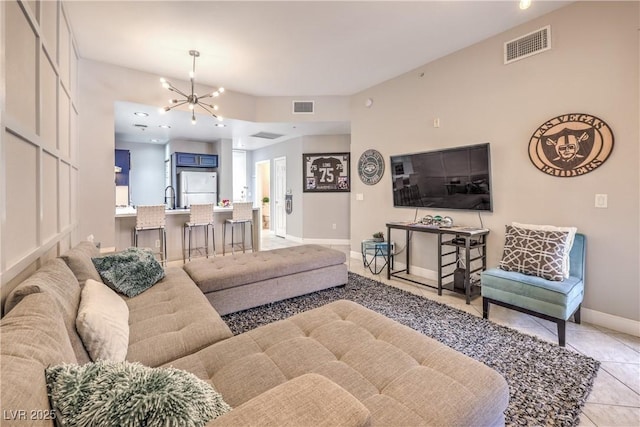 91 E Agate Ave Unit 204, Las Vegas, NV 89123 - living area featuring a chandelier, light tile patterned flooring, and baseboards