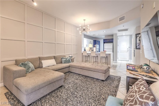 91 E Agate Ave Unit 204, Las Vegas, NV 89123 - living area with a decorative wall, light tile patterned floors, and a chandelier