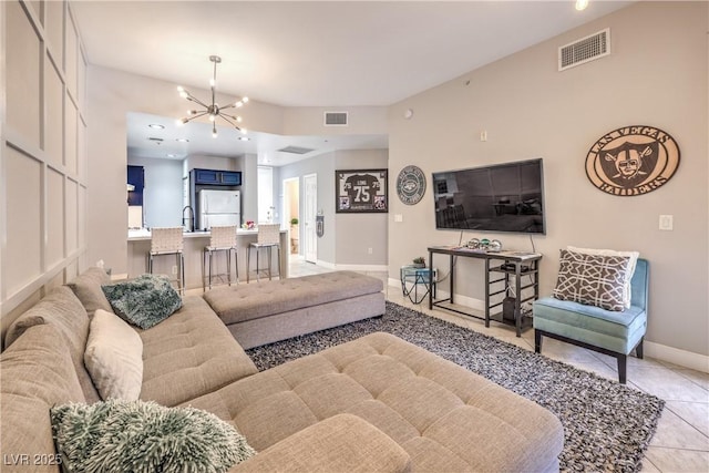 91 E Agate Ave Unit 204, Las Vegas, NV 89123 - living room with light tile patterned flooring, baseboards, and a chandelier