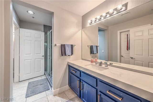 91 E Agate Ave Unit 204, Las Vegas, NV 89123 - bathroom with tile patterned floors, vanity, a stall shower, and baseboards