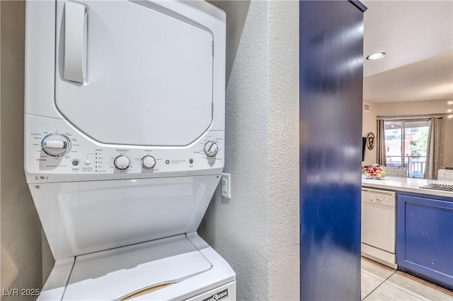 91 E Agate Ave Unit 204, Las Vegas, NV 89123 - laundry room with stacked washing machine and dryer, a textured wall, and light tile patterned flooring