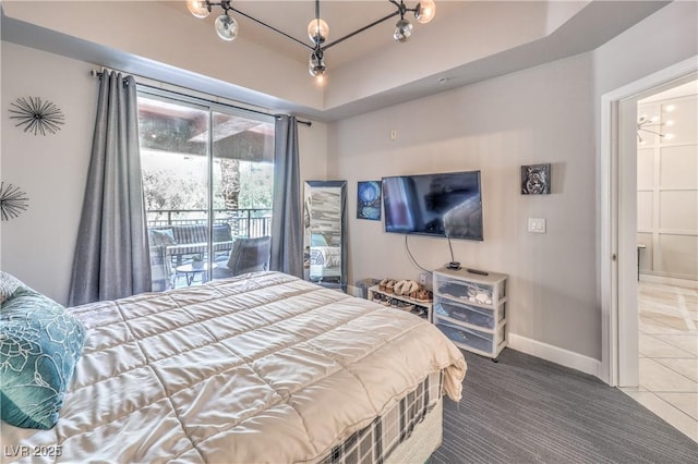 91 E Agate Ave Unit 204, Las Vegas, NV 89123 - carpeted bedroom with access to outside, baseboards, a tray ceiling, tile patterned floors, and connected bathroom